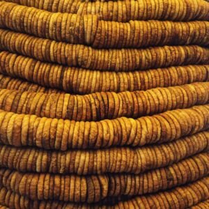 dry fruits and seeds A stacked close-up view of rustic dried figs showcasing texture and pattern.