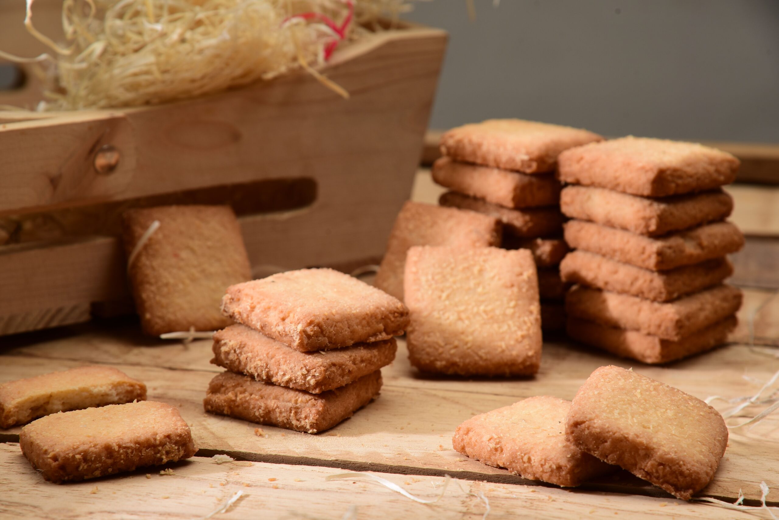 pexels photo 14757522 14757522 Appetizing shortbread cookies stacked on a rustic wooden surface, perfect for food photography.