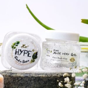 Aloe vera skincare products on a natural stone setting with greenery.