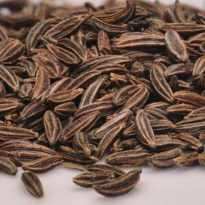 Detailed close-up of aromatic caraway seeds, perfect for culinary use, captured in a kitchen environment.