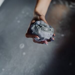 A soothing bath moment featuring soap and gentle bubbles in a relaxed setting.