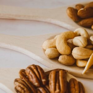 dry fruits and seeds Close-up of assorted nuts in wooden spoons showcasing a healthy and organic snack option.