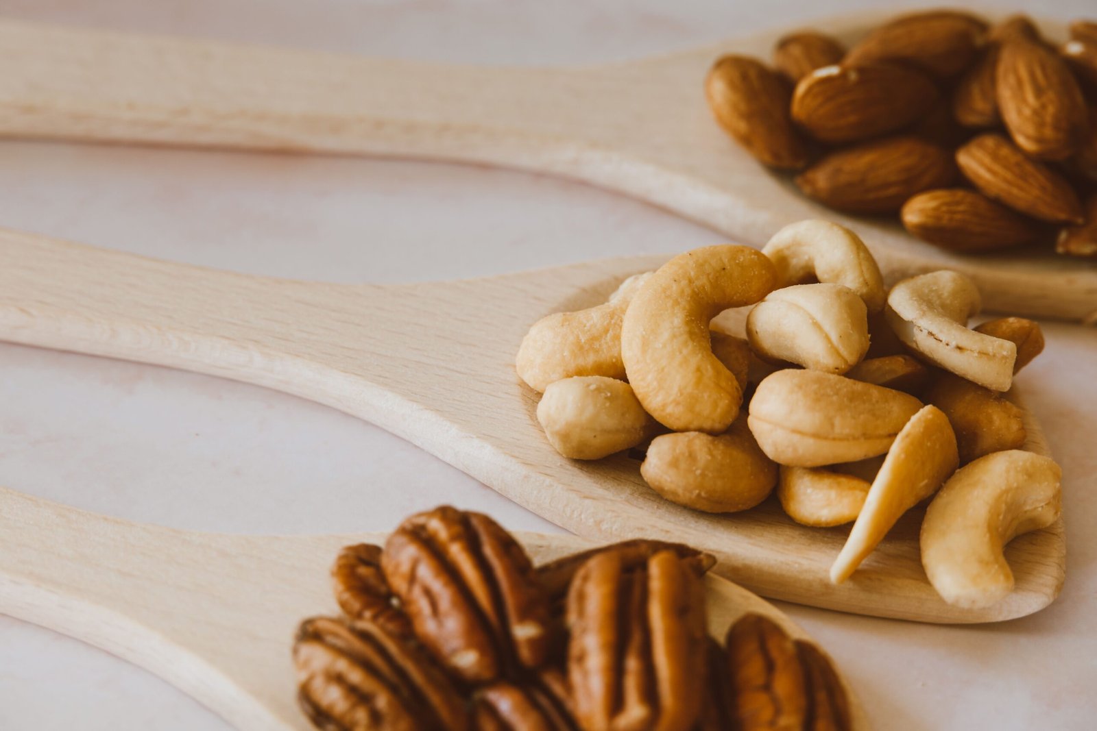 pexels photo 5507644 5507644 Close-up of assorted nuts in wooden spoons showcasing a healthy and organic snack option.