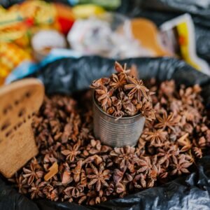 Star anise displayed in a can on a market stall, showcasing its rich, aromatic spice used in cooking.