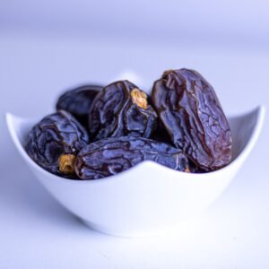 dry fruits and seeds A close-up of fresh dates in a decorative white bowl, symbolizing Ramadan.