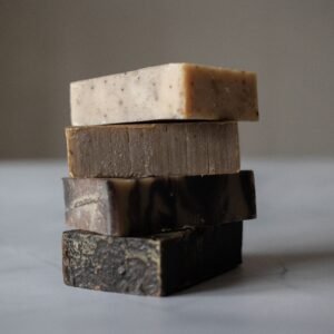 Stack of aromatic natural handmade soaps placed on gray table against blurred background