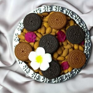 An artistic food arrangement featuring almonds and cookies on a plate with satin backdrop.