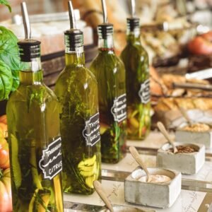 Infused olive oil bottles with herbs and spices on a gourmet kitchen counter.